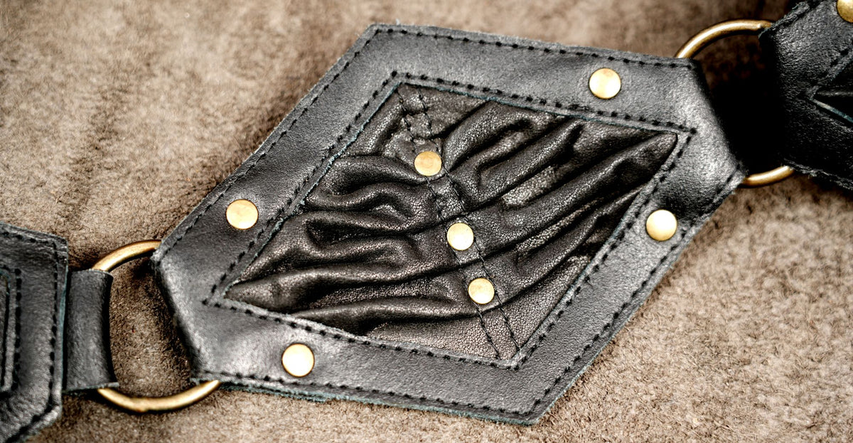 Black leather utility belt hip bag with ruched front flap and antique brass studs