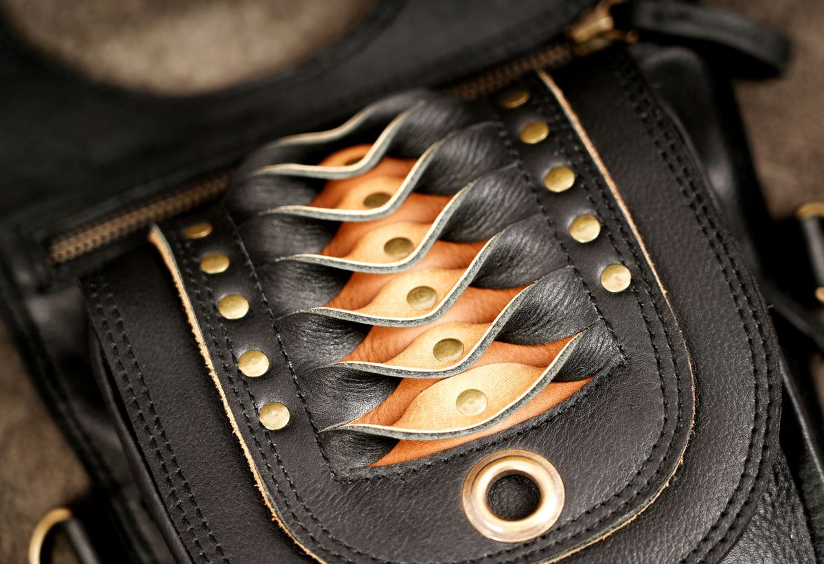 Unisex black leather double holster harness bag for alternative fashion and festival outfits.