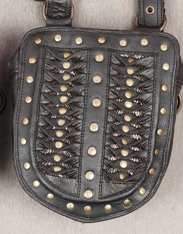 Gothic black leather thigh harness with antique brass hardware and detailed stitching