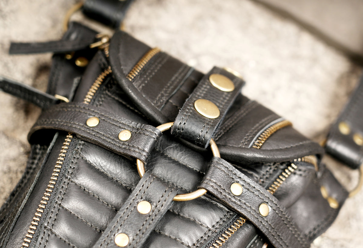 Black leather shoulder harness with two utility pouches for festivals and everyday essentials