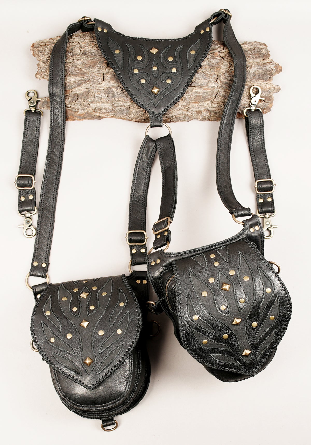 Handmade leather double hip pouch harness with intricate stitched patterns and metal ring attachments.