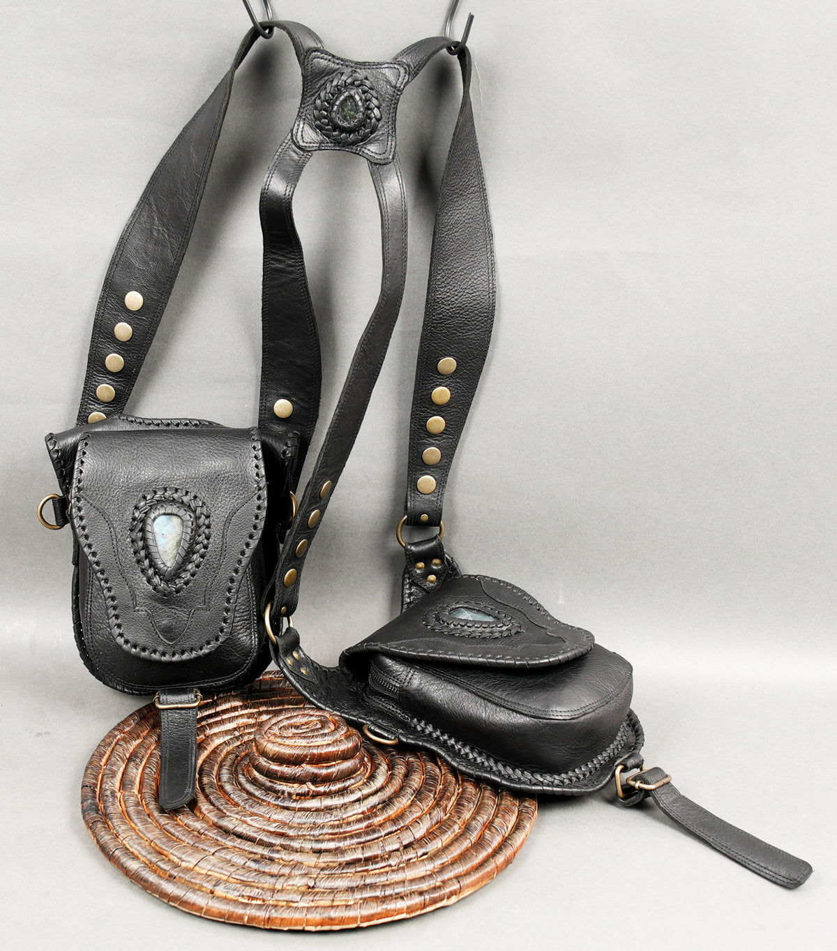 Black leather hip bags with natural labradorite gemstone decorations and braided detailing