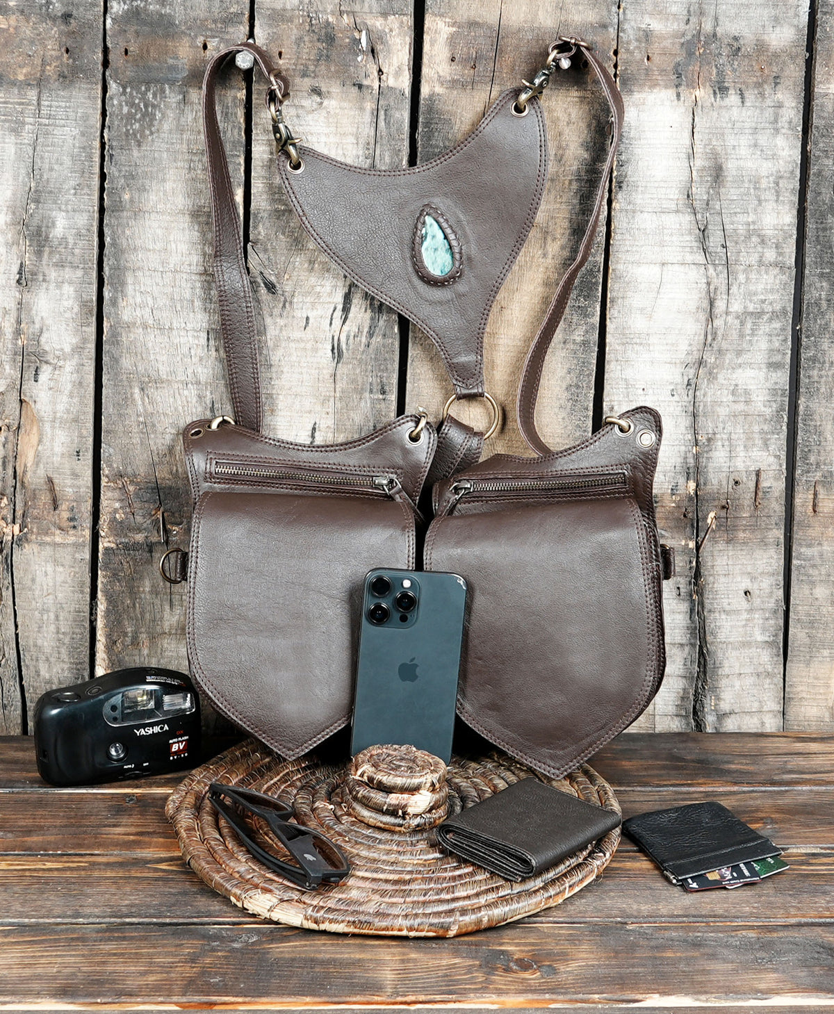 Brown leather hip harness with central turquoise stone and stitched detailing
