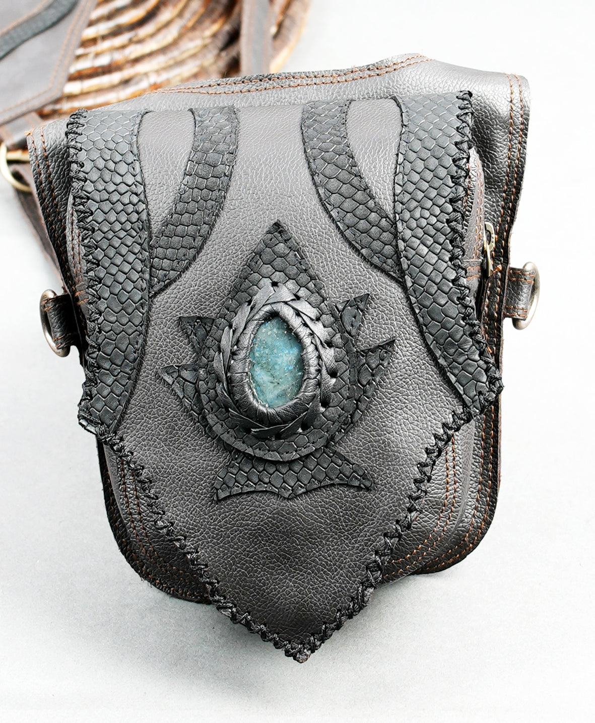 Black and grey leather festival harness with two hip pouches and adjustable shoulder straps.
