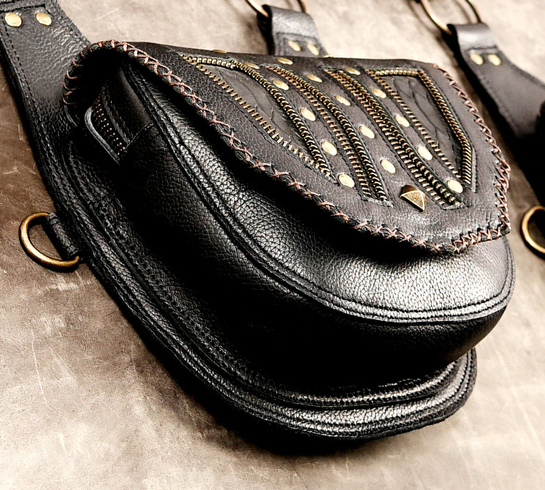 Black leather festival holster set with antique-tone metal rings and clasps