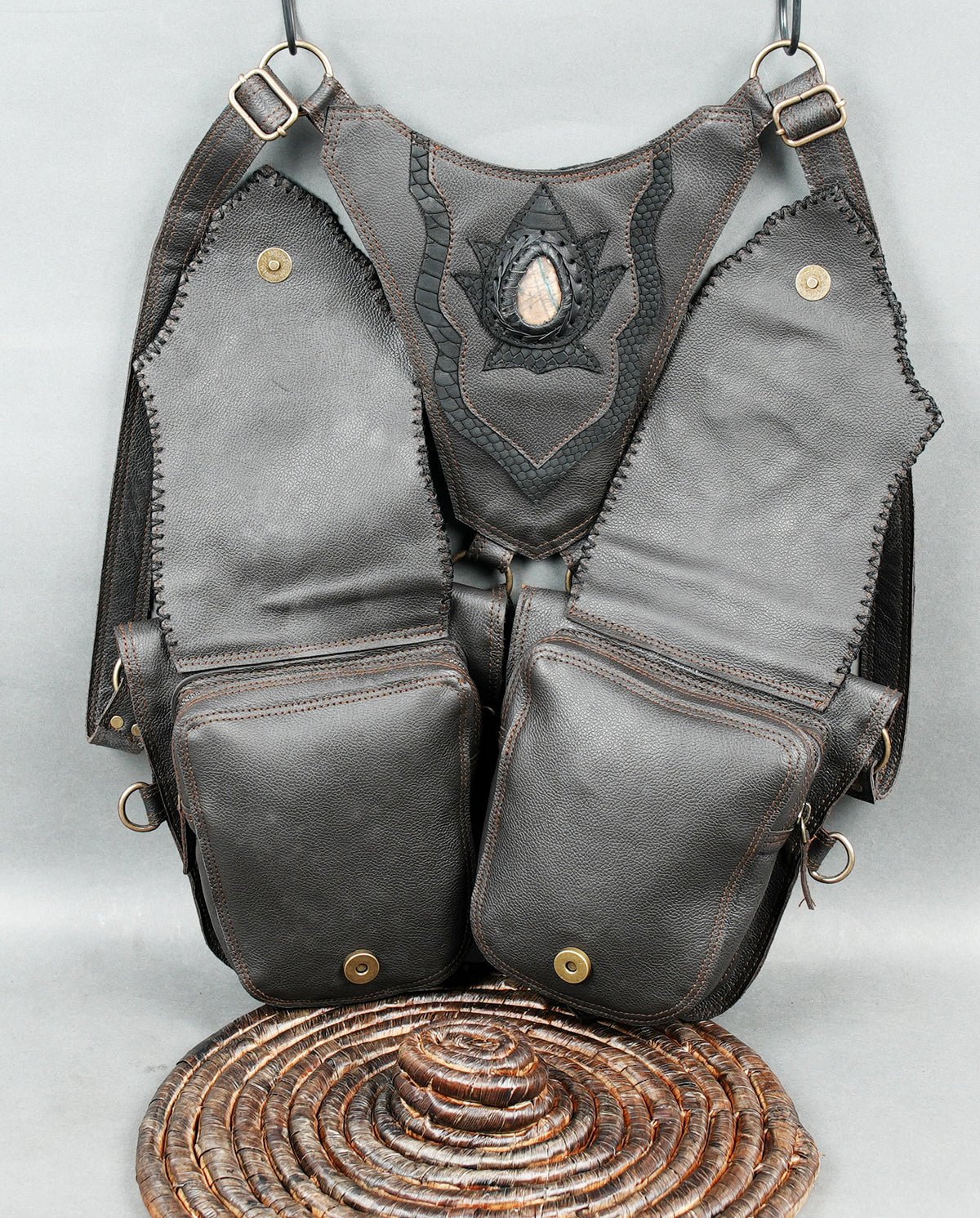 Steampunk leather hip pouch set with decorative grey panels metal rings and gemstone accents.