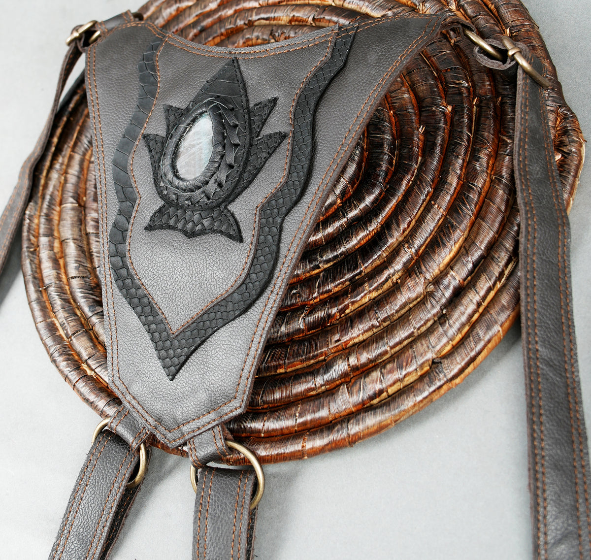 Artisan leather shoulder harness with twin hip bags braided leather trim and metal fittings.