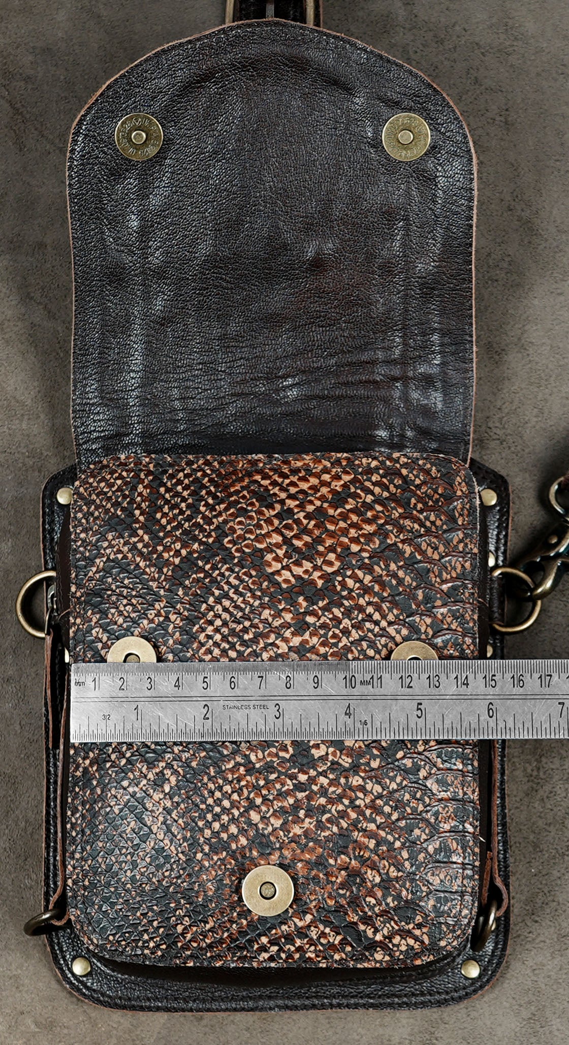 Festival wear leather shoulder rig with textured brown panels and matching side bags.