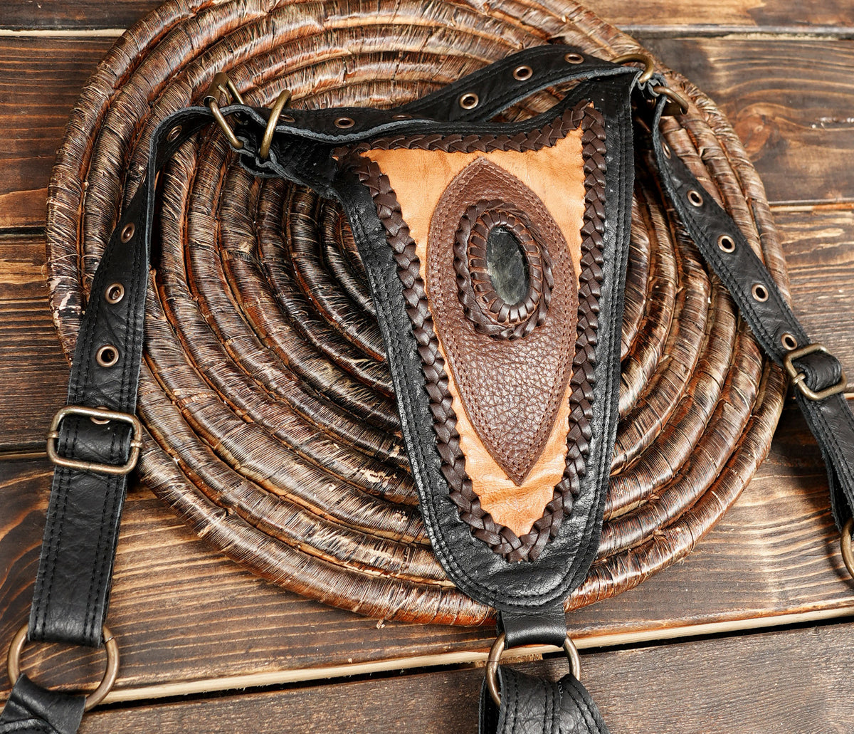 Black leather chest harness bag with adjustable buckled straps