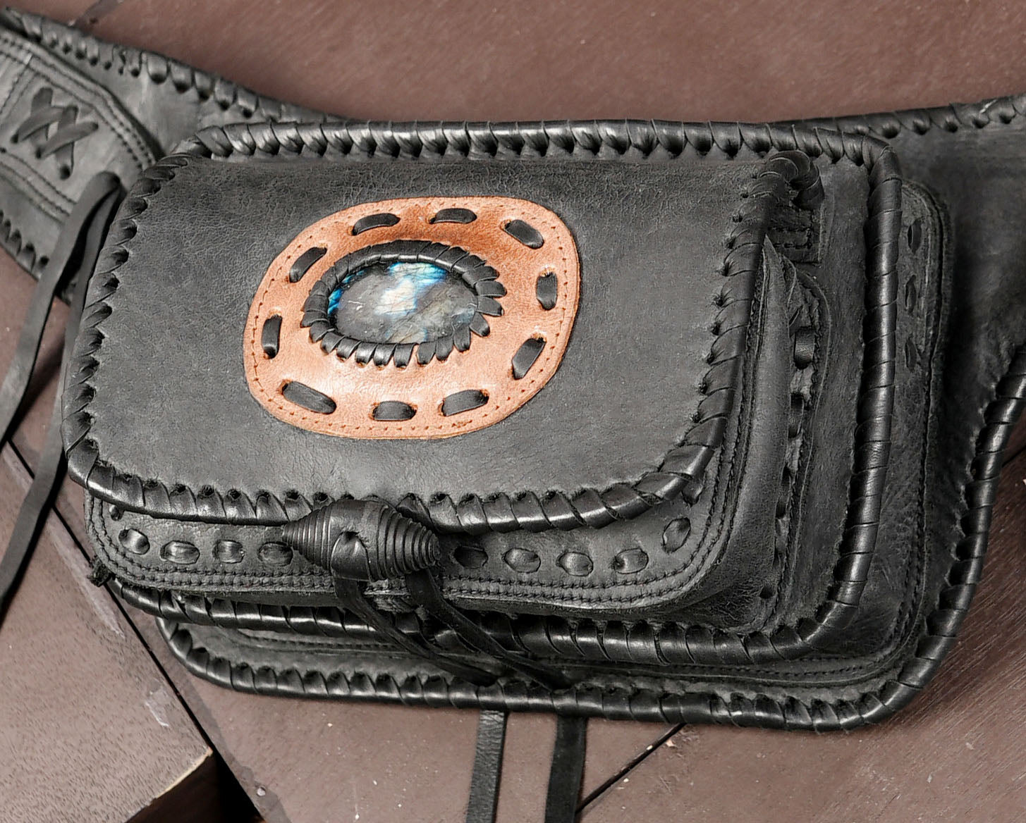Handcrafted leather bag with labradorite stone and braided edge