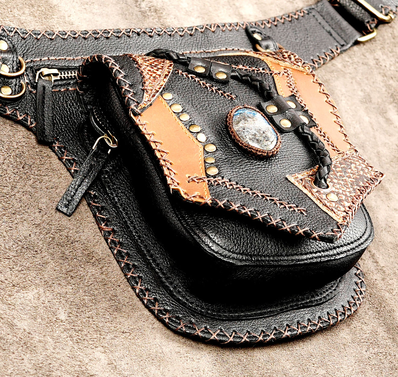 Handcrafted leather bag with natural stone pendant, flat lay view
