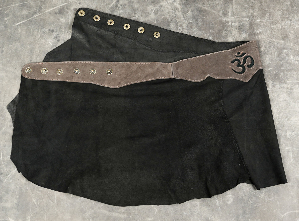Handcrafted leather festival skirt styled on stone background