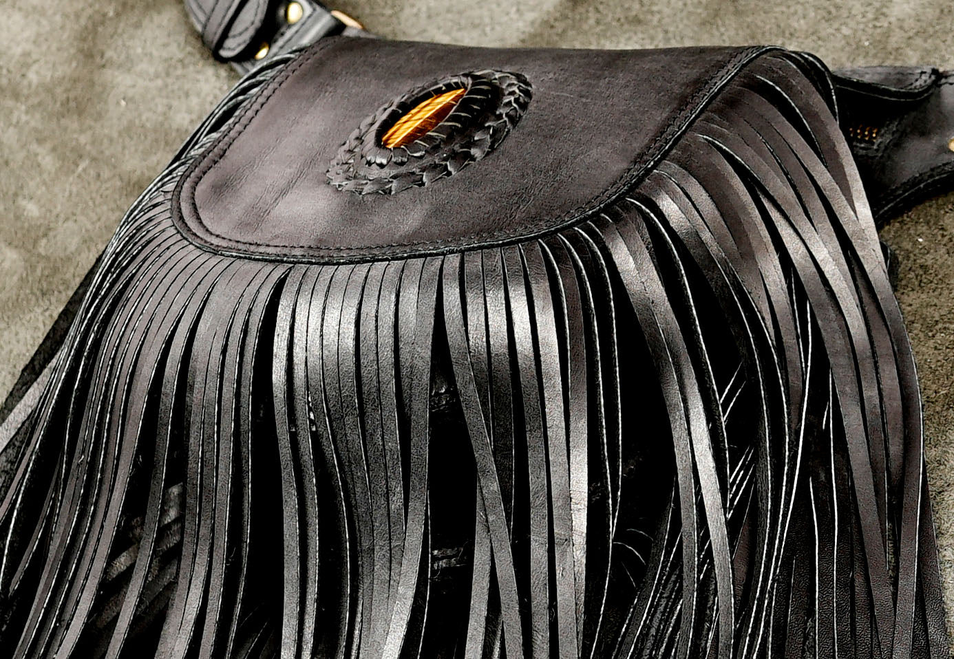 Handcrafted leather pouch with tiger eye stone and fringe trim