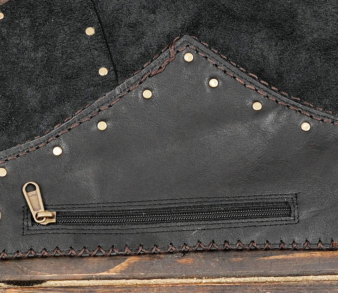 Handcrafted leather skirt with rows of studs, close up view