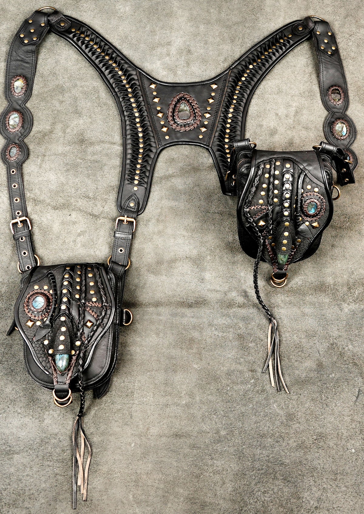 Edgy black leather hip bag harness with embellished flaps and adjustable buckle straps
 