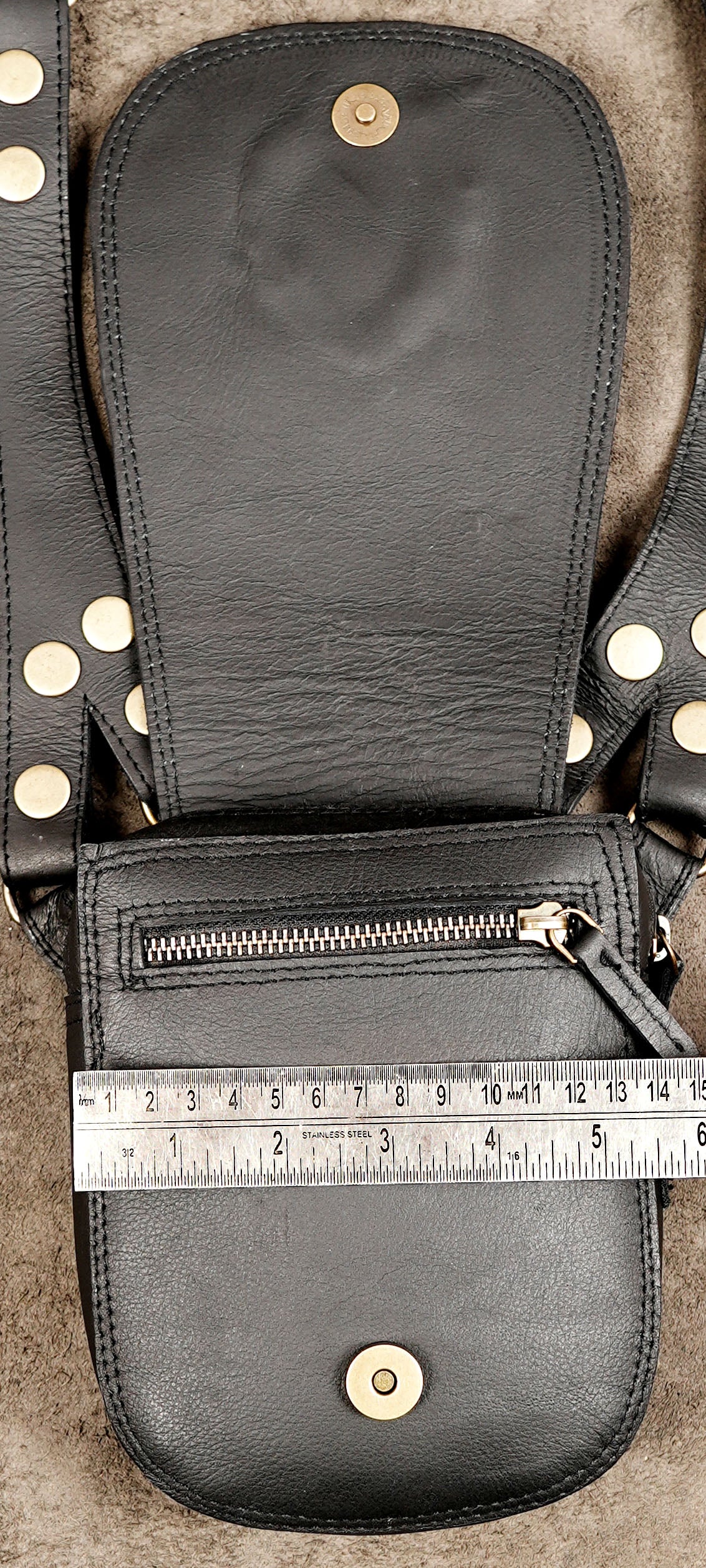 Black leather utility bag with matching pouches and decorative stone accents