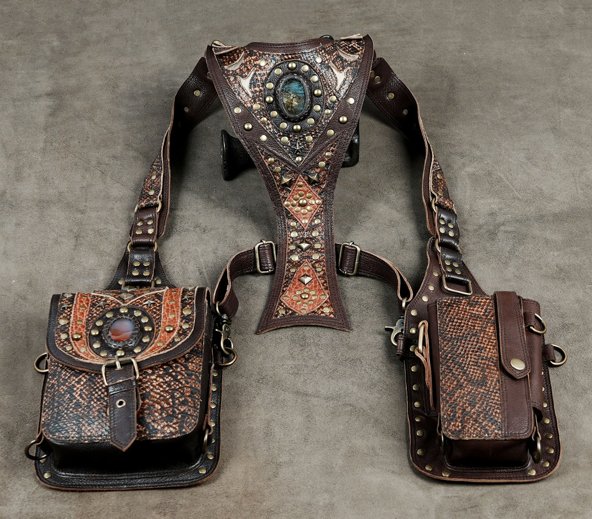 Festival wear leather shoulder rig with textured brown panels and matching side bags.