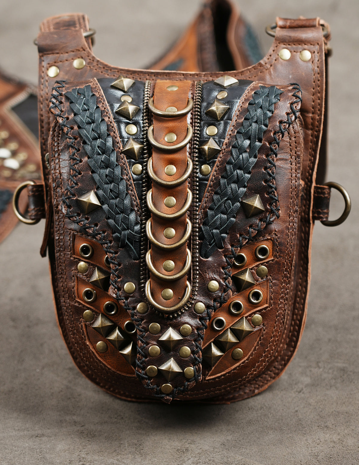 Brown leather shoulder holster set with detailed studwork and black decorative panels