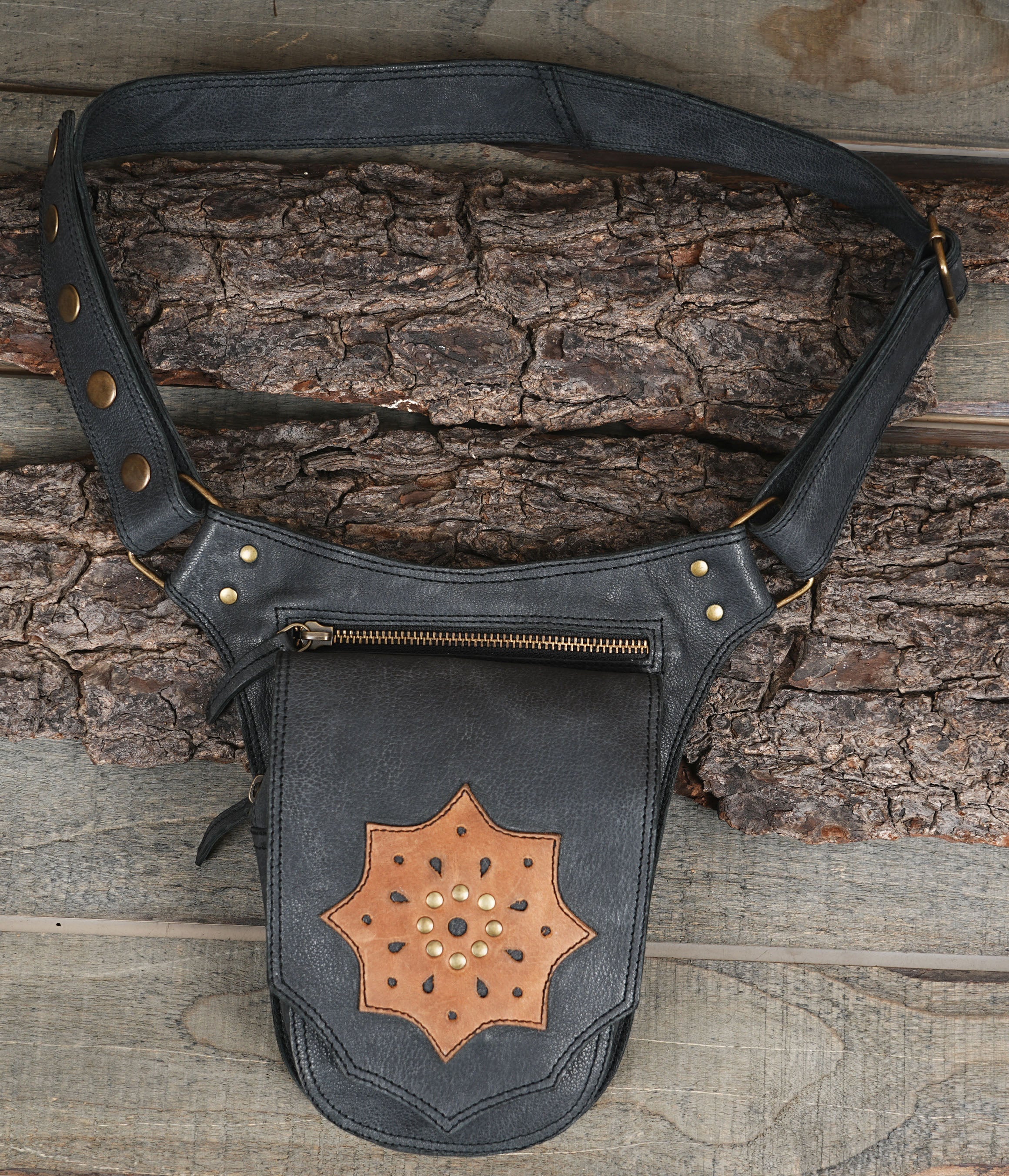 Handmade black leather hip bag with tooled star medallion and brass studs
