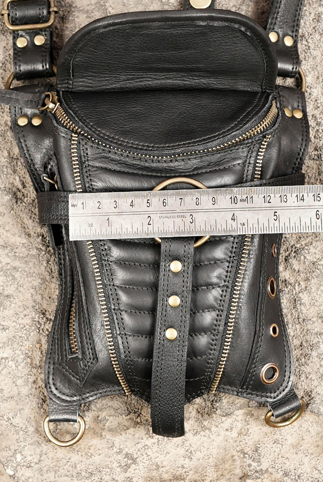 Unisex steampunk hip bag with black leather construction and adjustable harness straps