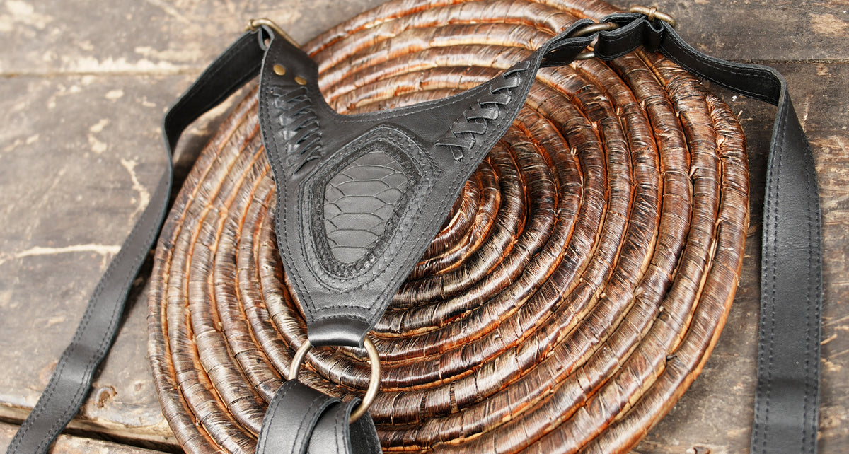 Black leather Burning Man harness with dual pockets and decorative embossed panels