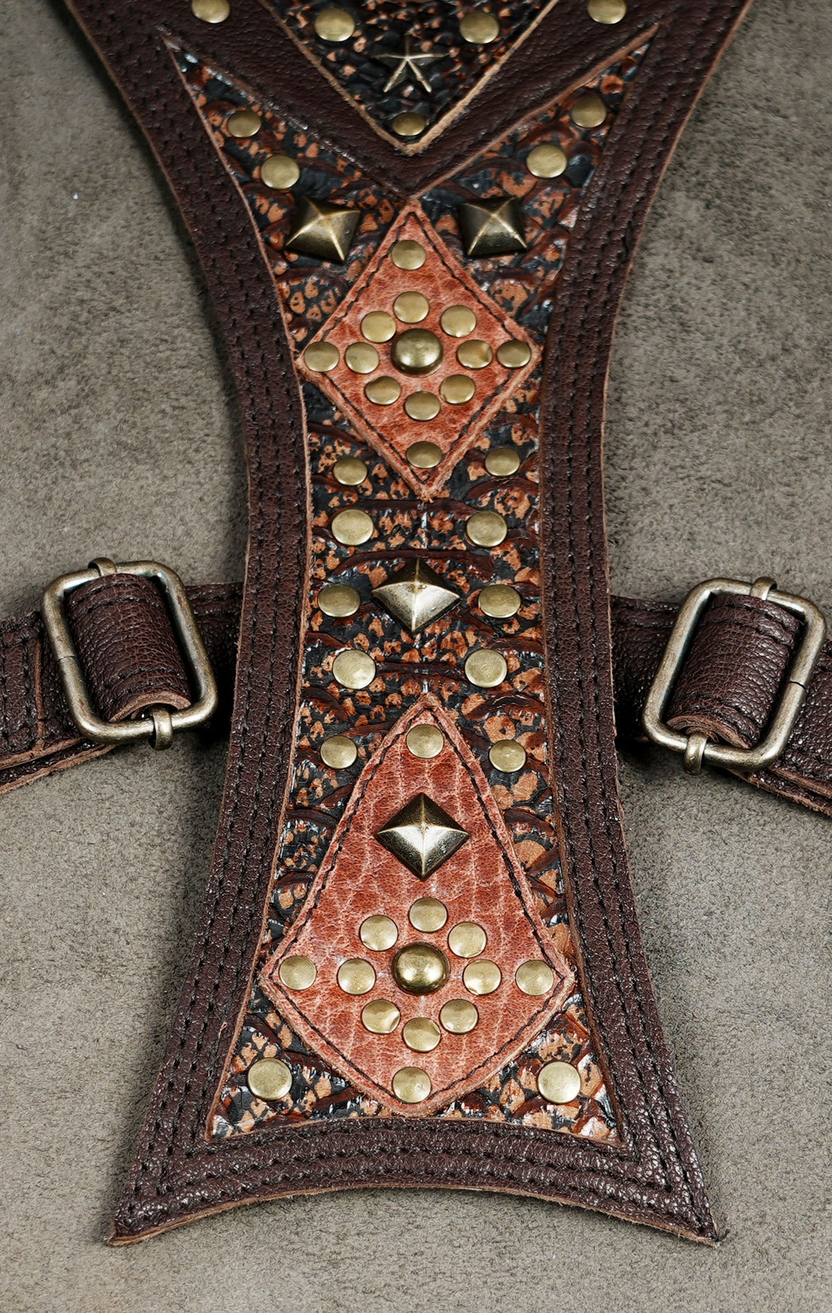 Steampunk leather utility bag set with brown straps, patterned panels, and metal embellishments.
