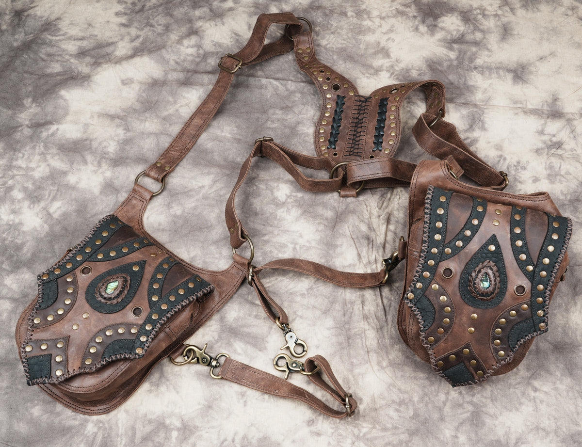 Artisan leather harness accessory with twin side pouches for hands-free festival carrying.