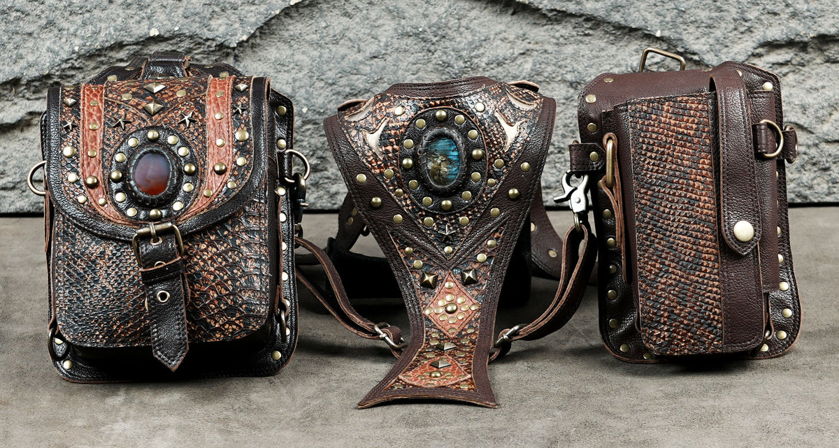 Handmade brown leather shoulder holster with embossed patterns and antique brass hardware.
