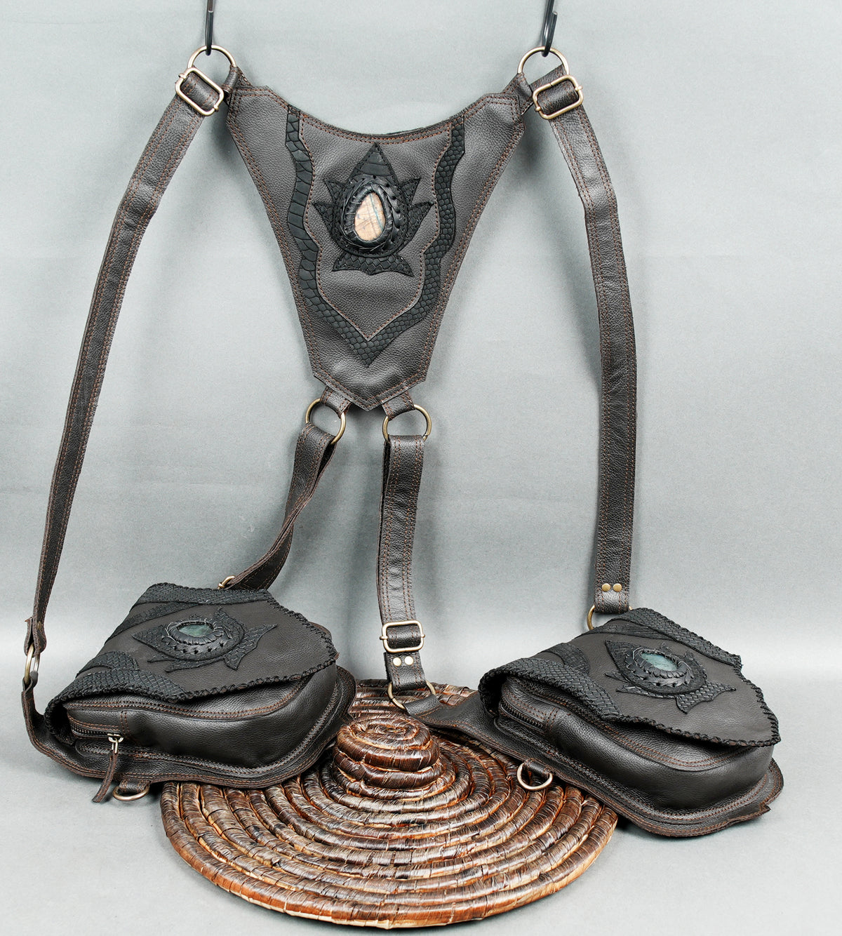 Handmade leather utility harness with twin front pouches and decorative metal hardware.