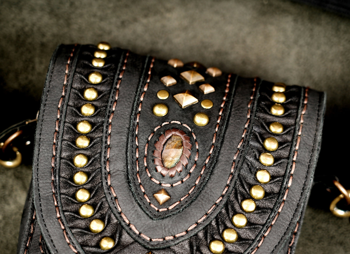 Studded black leather waist pouch with adjustable strap and brass hardwareStudded black leather waist pouch with adjustable strap and brass hardware