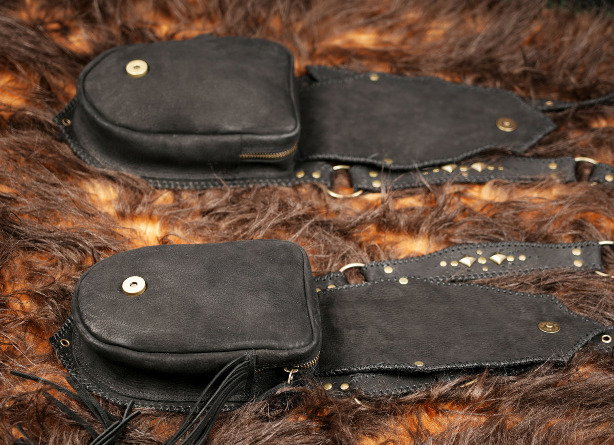 Handmade unisex black leather thigh harness with adjustable straps and intricate studded designs.
