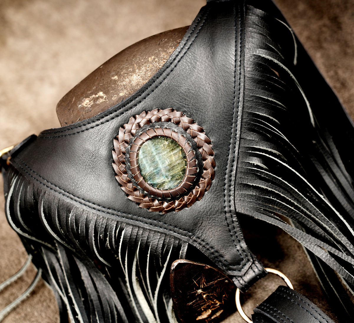 Motorcycle rider black leather shoulder holster with twin side bags and back tassel detail.
