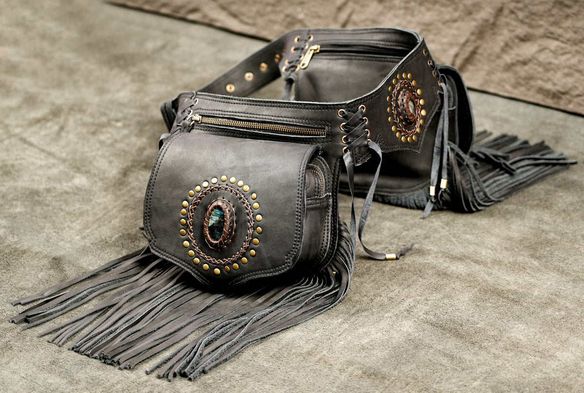 Black leather fringe belt bag with gold-tone studs and turquoise stone accents.
