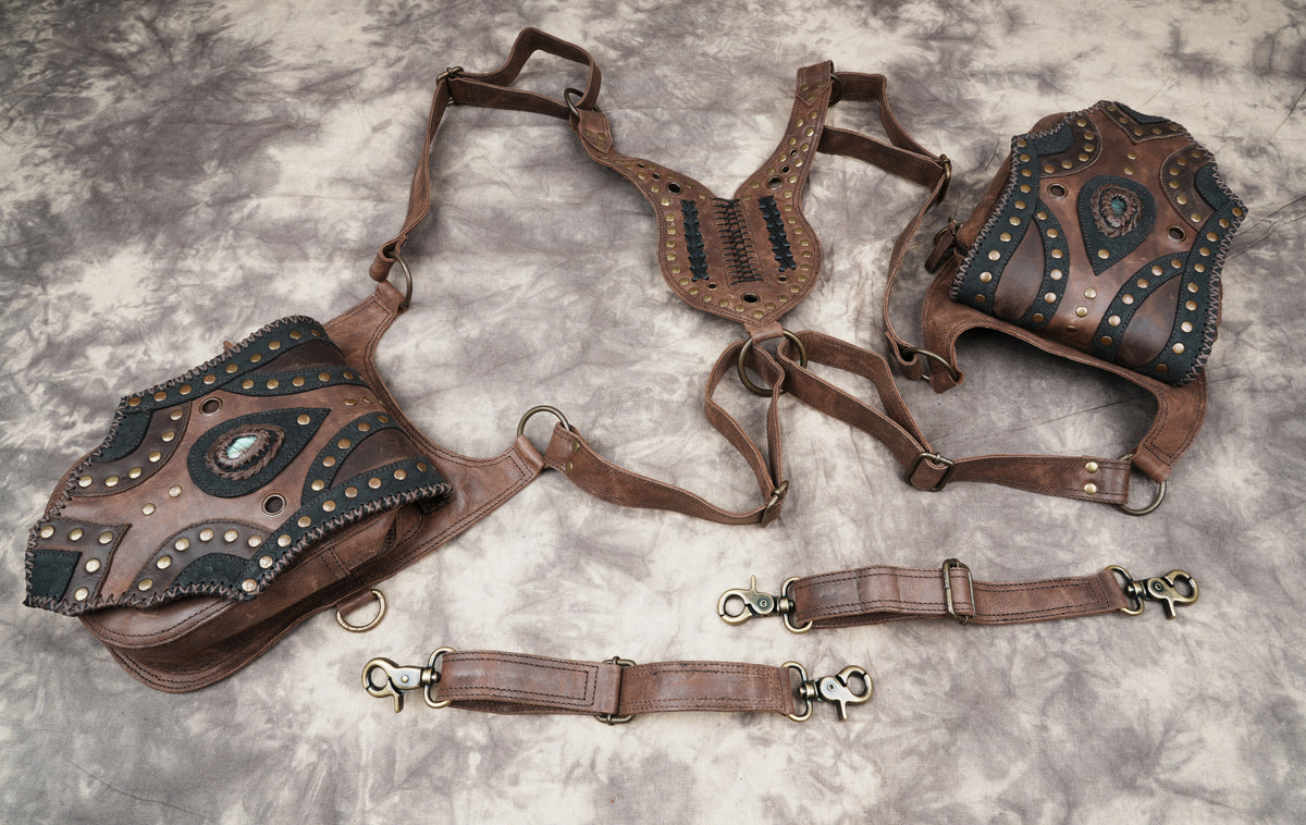 Brown leather utility harness for cosplay costumes with studded flaps and gemstone embellishments.