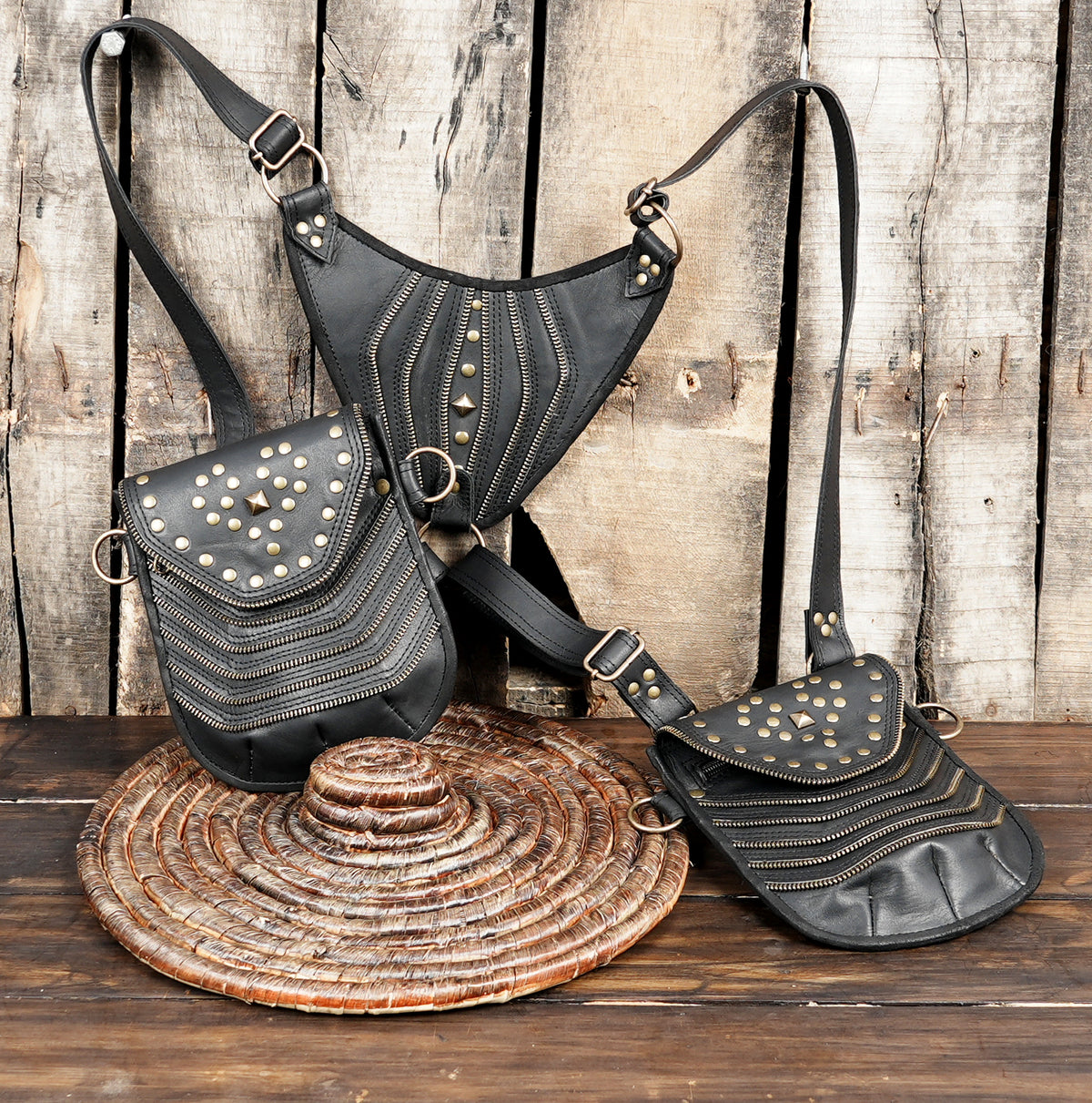 Black leather crossbody style harness with two hip pouches and metal ring attachments
 