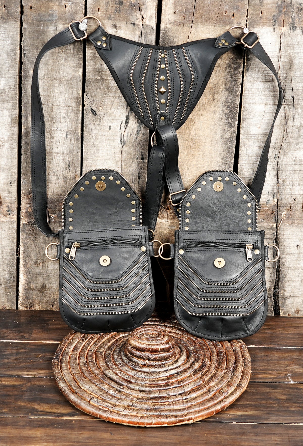Festival wear black leather harness bag with twin pockets and antique brass tone studs