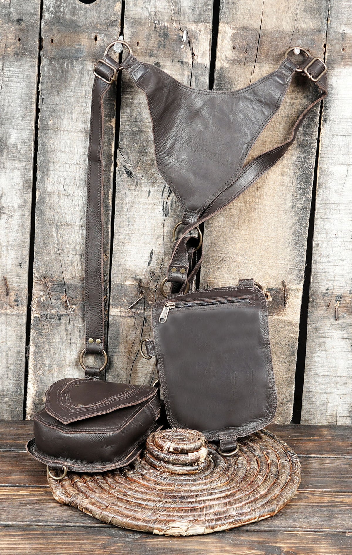 Gothic festival shoulder harness with dark leather pouches and decorative metal studs