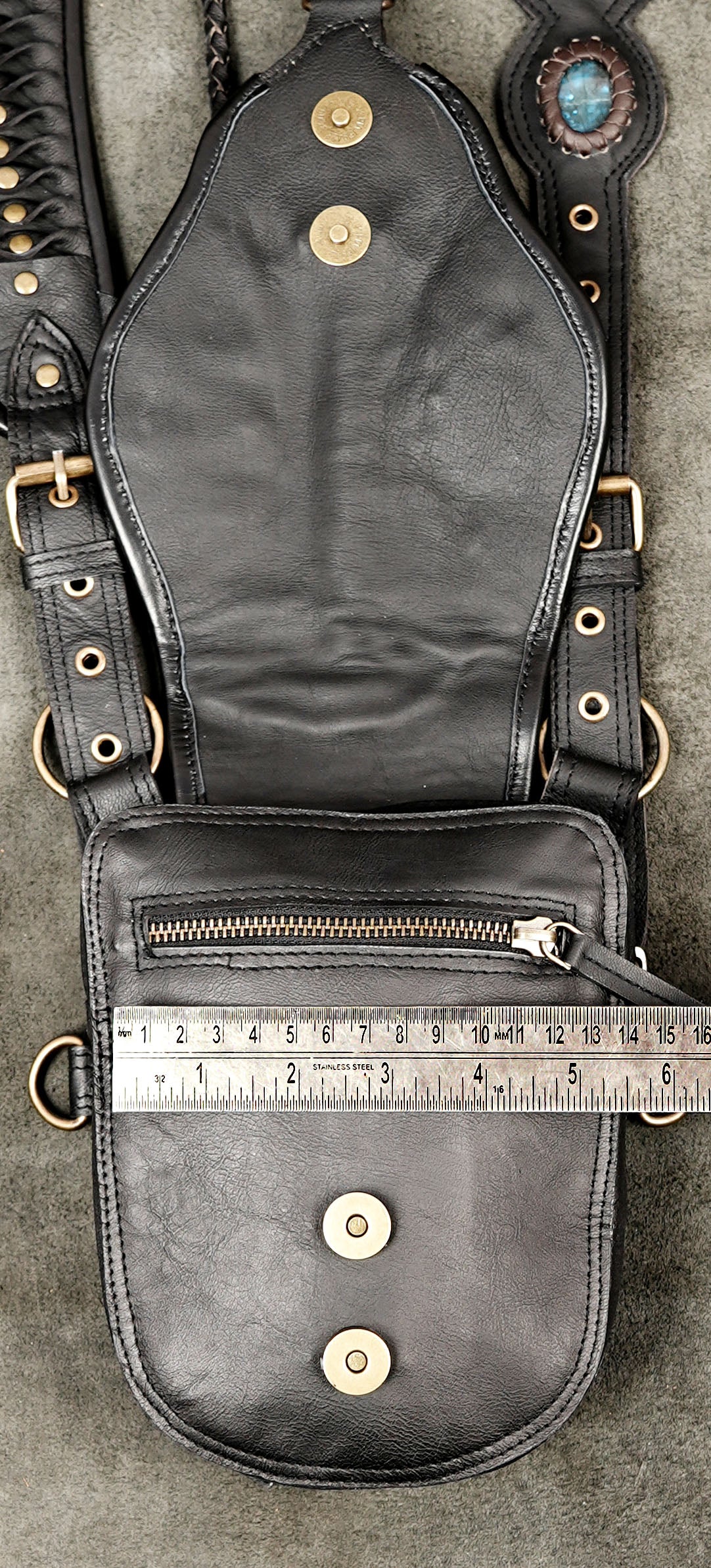 Steampunk inspired black leather harness with matching hip bags and ornamental stones
 