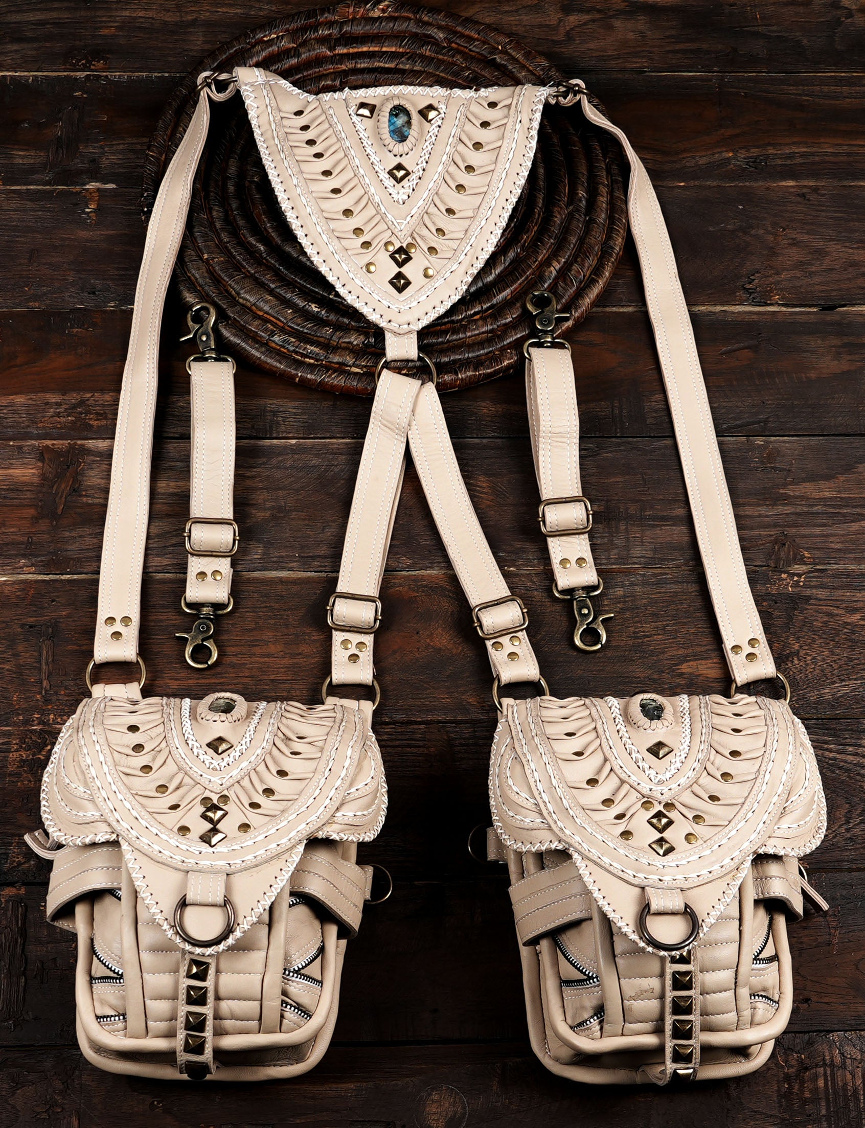 off-white dual pouch leather shoulder holster bag flat lay on rustic wood.