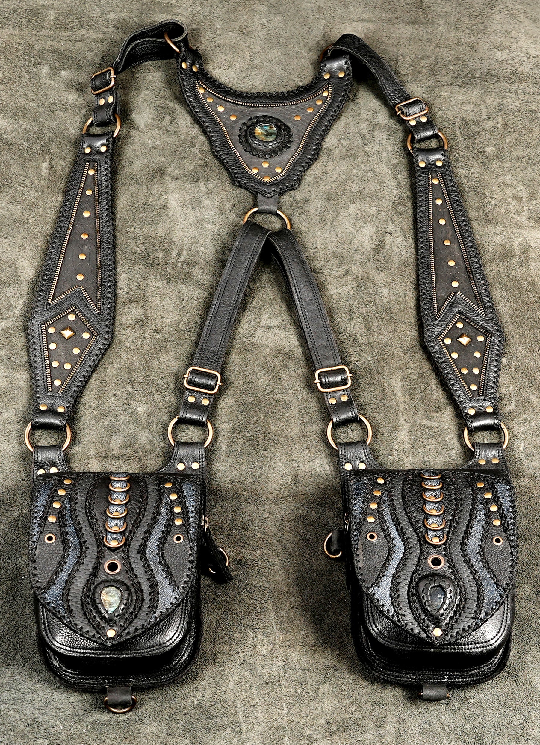 Streetwear black leather dual pouch holster bag worn across the torso as a functional fashion accessory