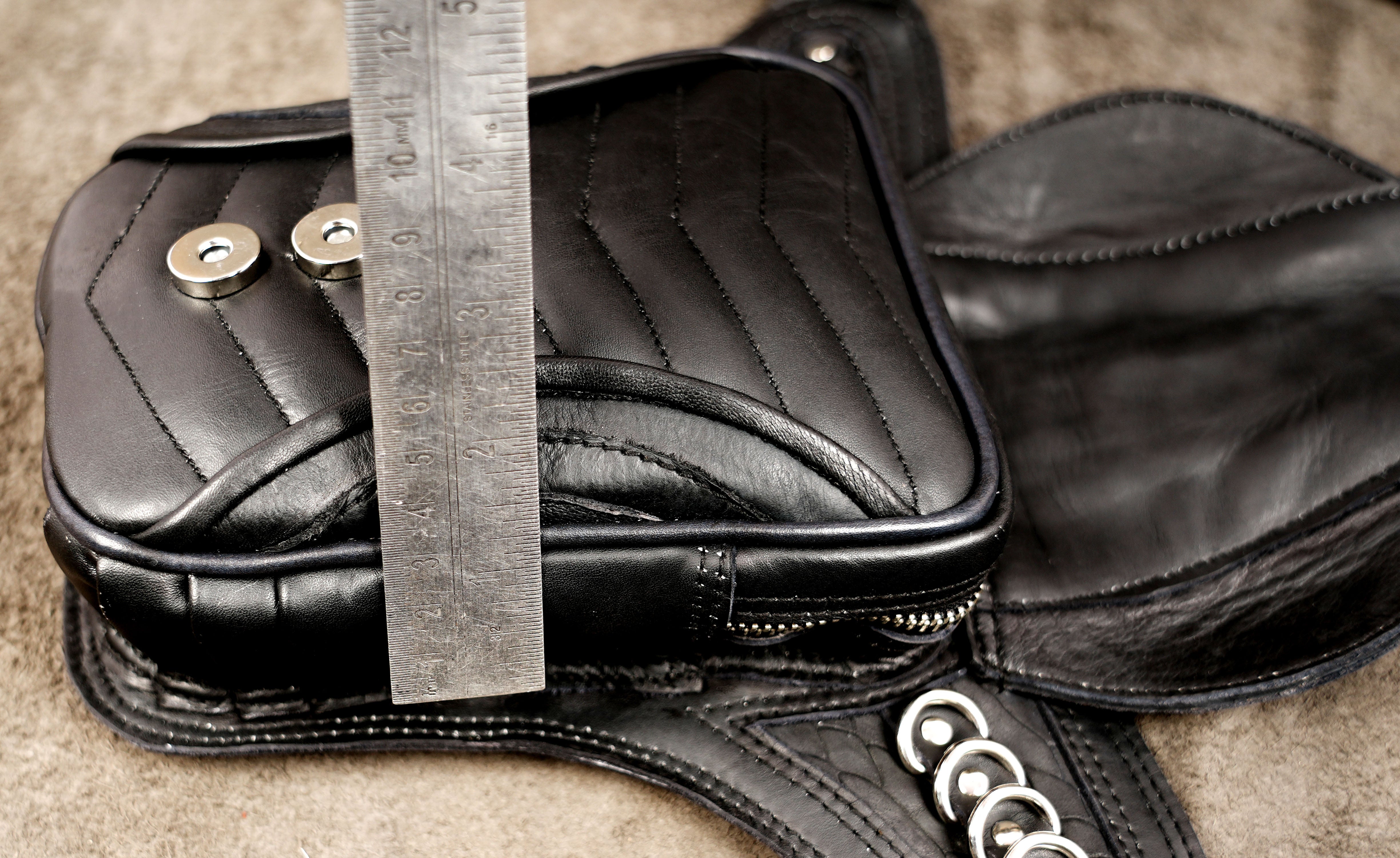 Leather biker pouch with vertical ring pattern, close up