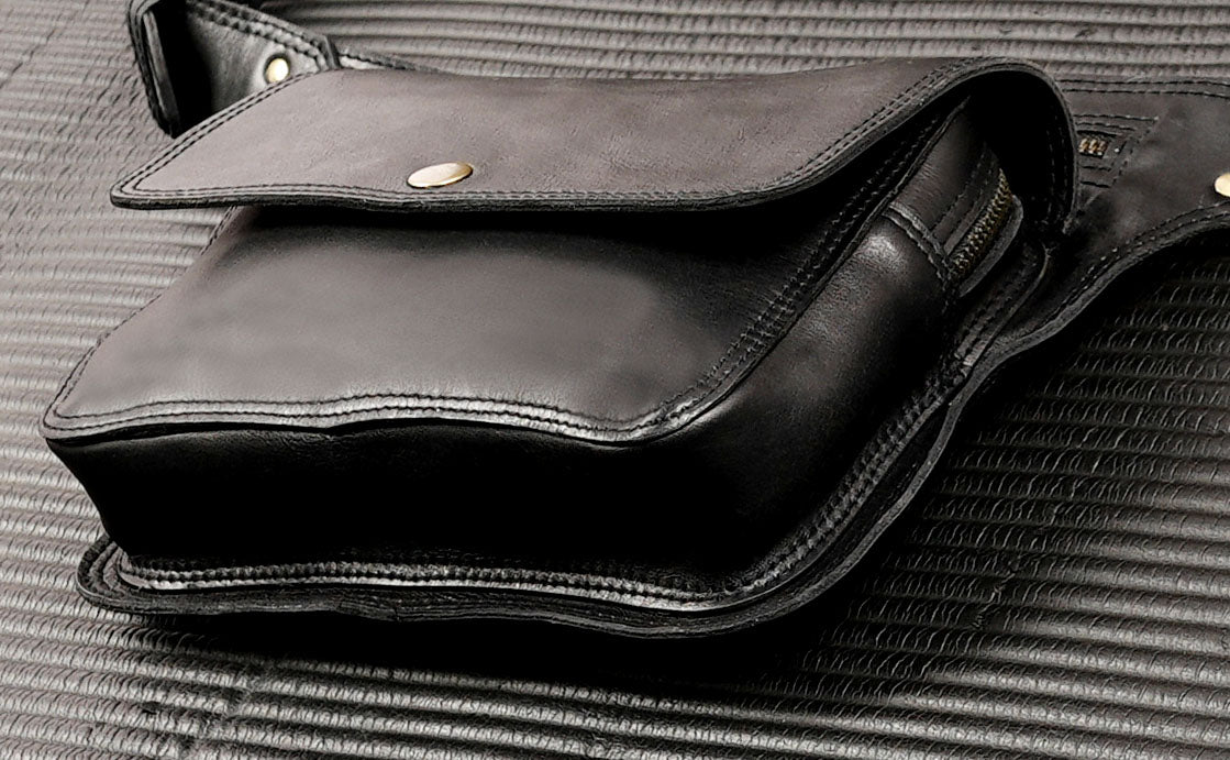 Leather bum bag in black with snap button flap, top view