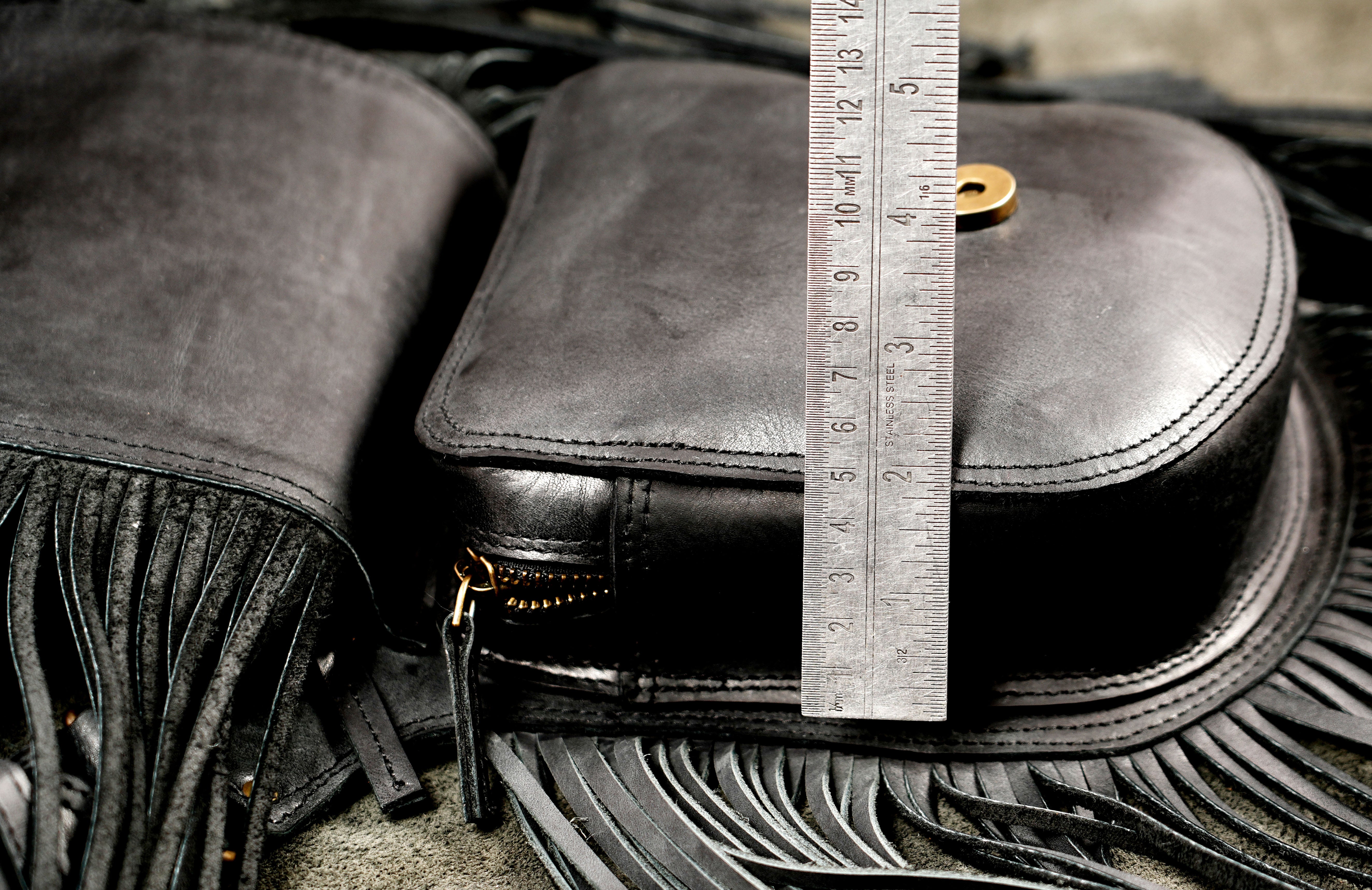 Leather crossbody bag with tiger eye stone, full fringe view