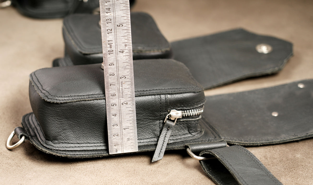 Leather survival belt with D-ring attachments visible