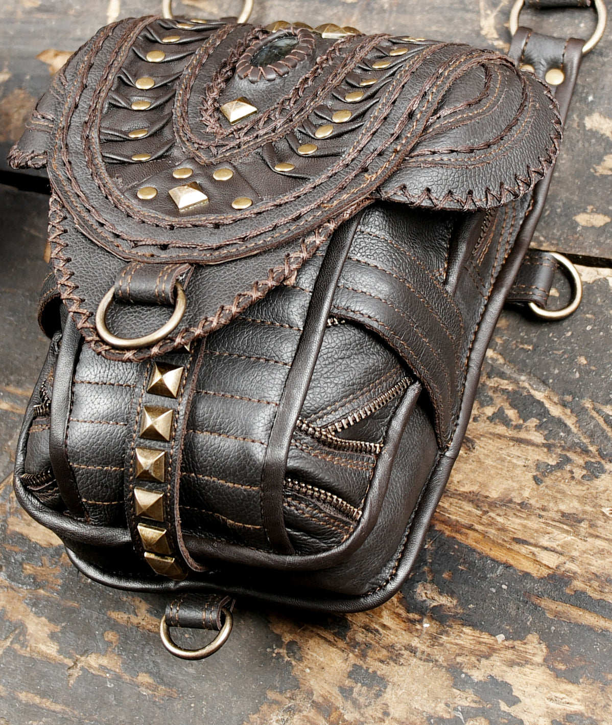 Steampunk leather harness bag with layered flaps and brass stud detailing