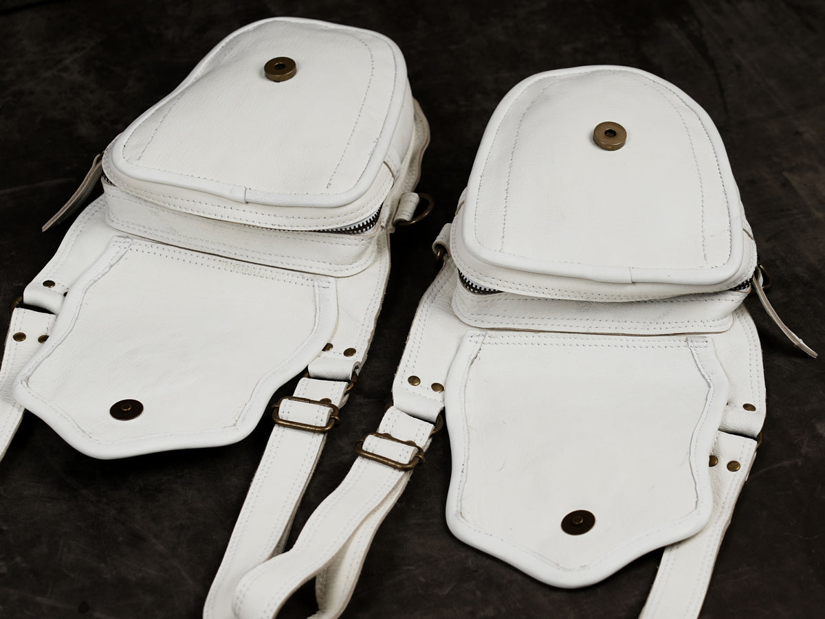 Light colored leather chest harness, full flat lay