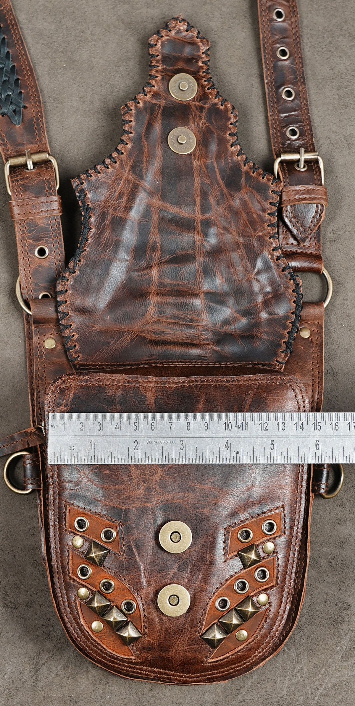 Gothic festival outfit accessory with brown leather shoulder straps and studded pouches