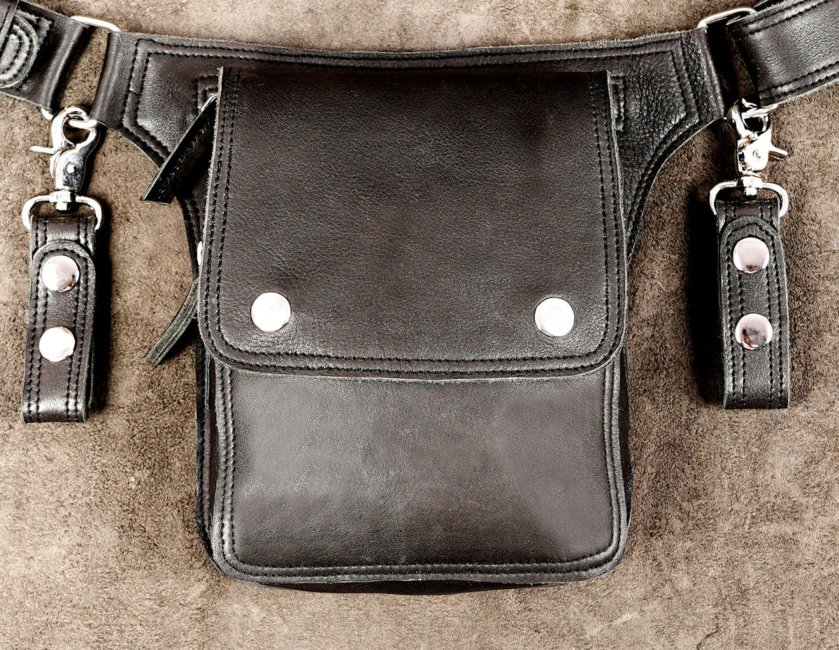 Minimalist leather waist bag with nickel silver D-rings, flat lay