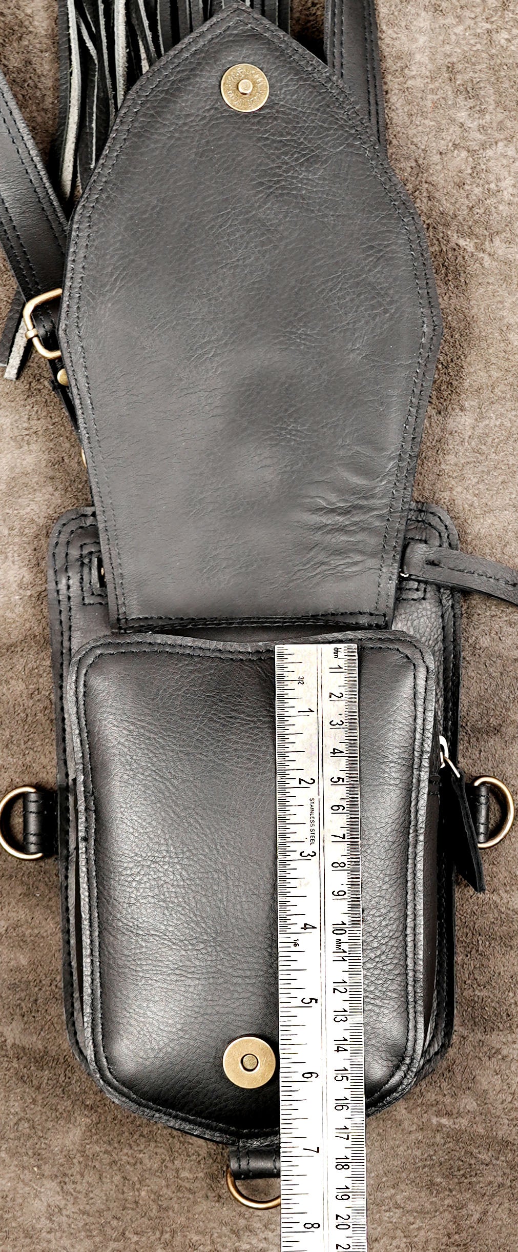 Bohemian festival body harness featuring dual utility pouches, leather fringe, and antique brass buckles.