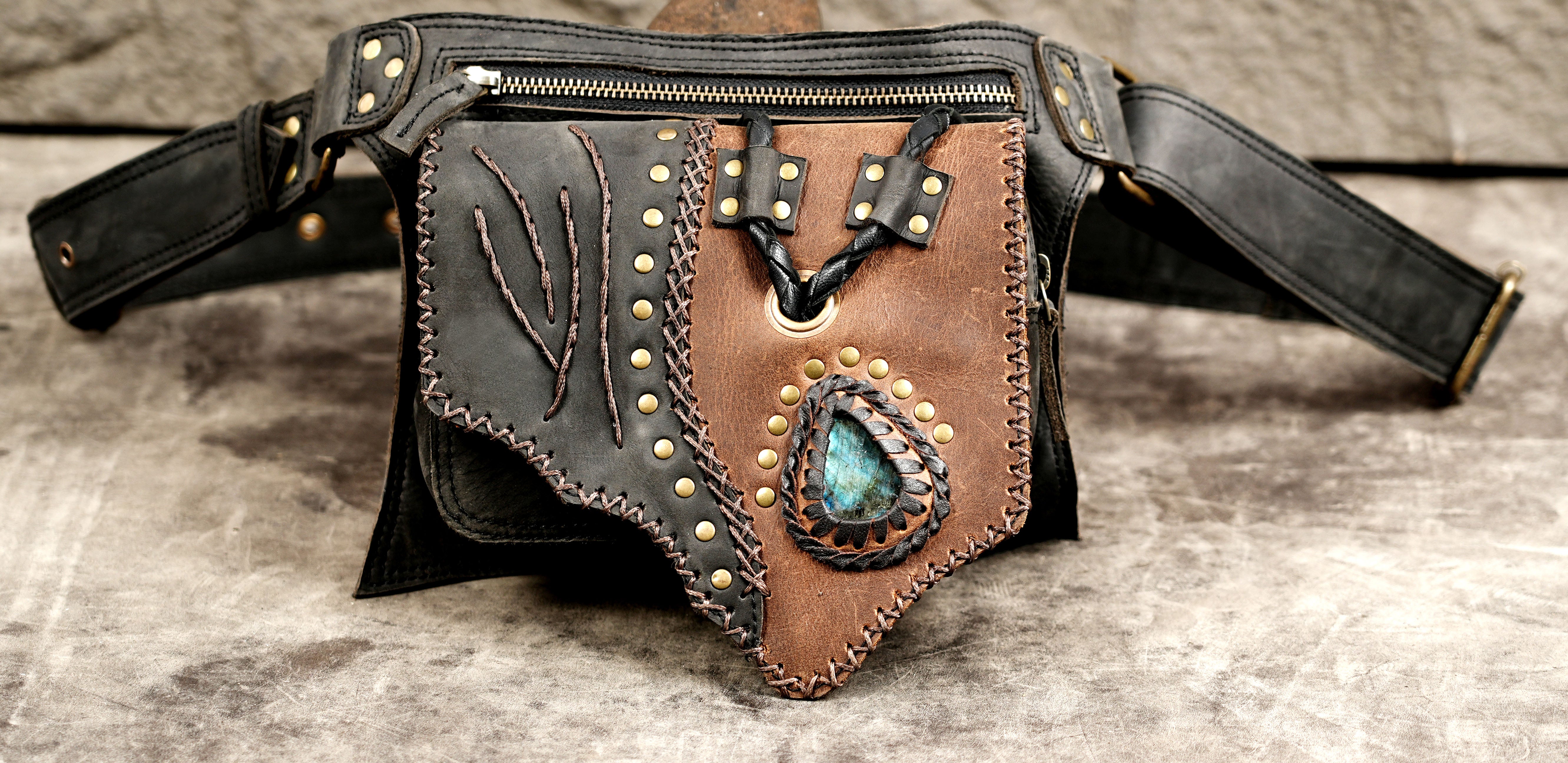 Multi-pocket leather waist bag with a zippered compartment